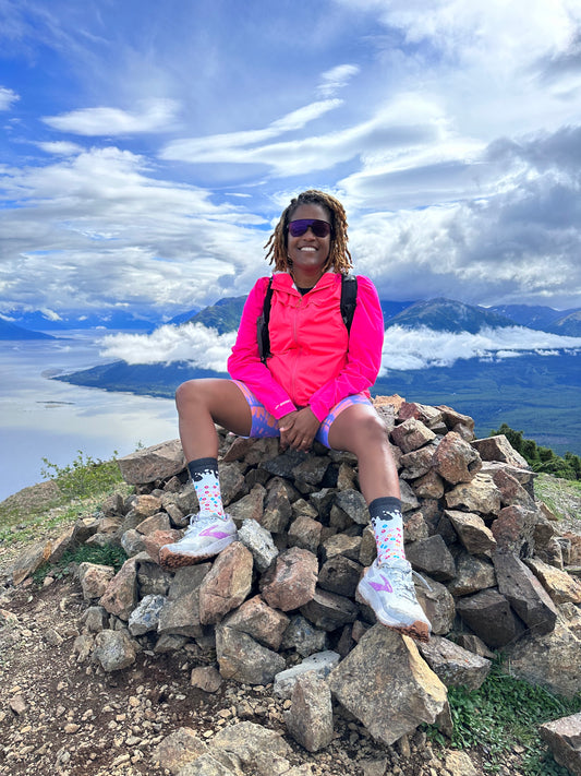 Alison Desir sitting on a rock in Alaska.
